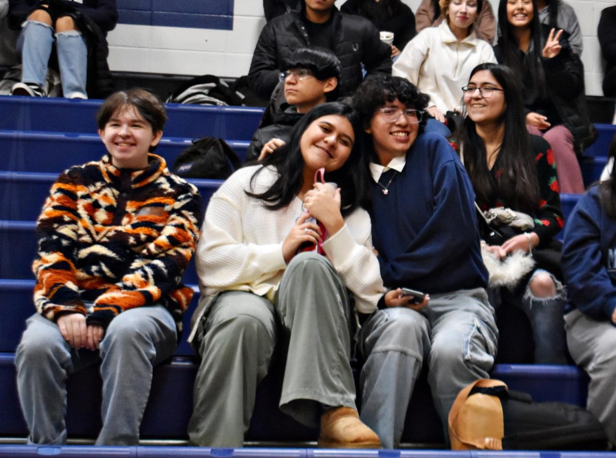 Juniors Miranda Bucio and Dex Vasquez sit alongside Miles Cooper during the assembly.