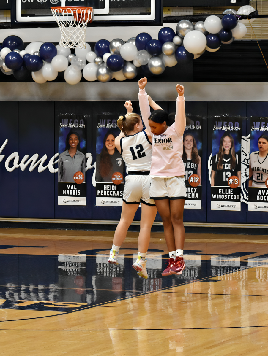 Sydney Bennema and Valerie Harris bump hips as the seniors are announced before the game on Feb. 2.