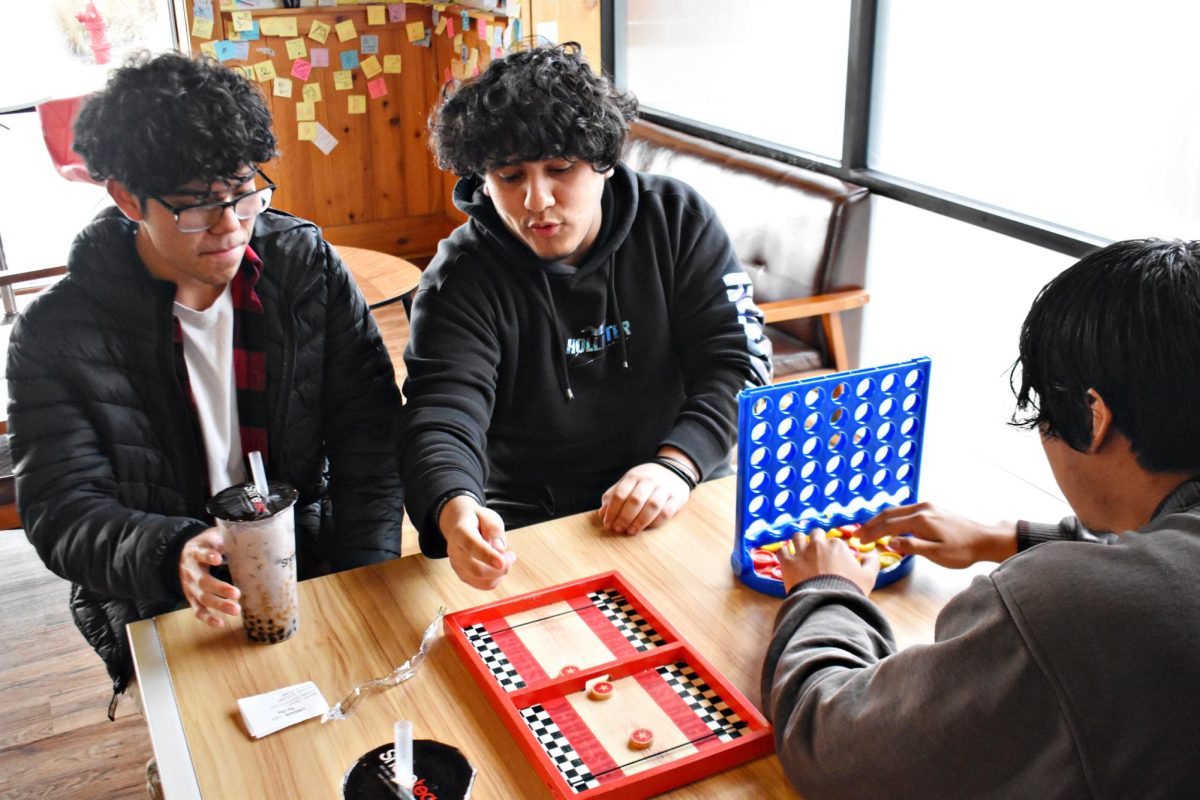 Students play Connect 4 while sipping boba on a spring afternoon.