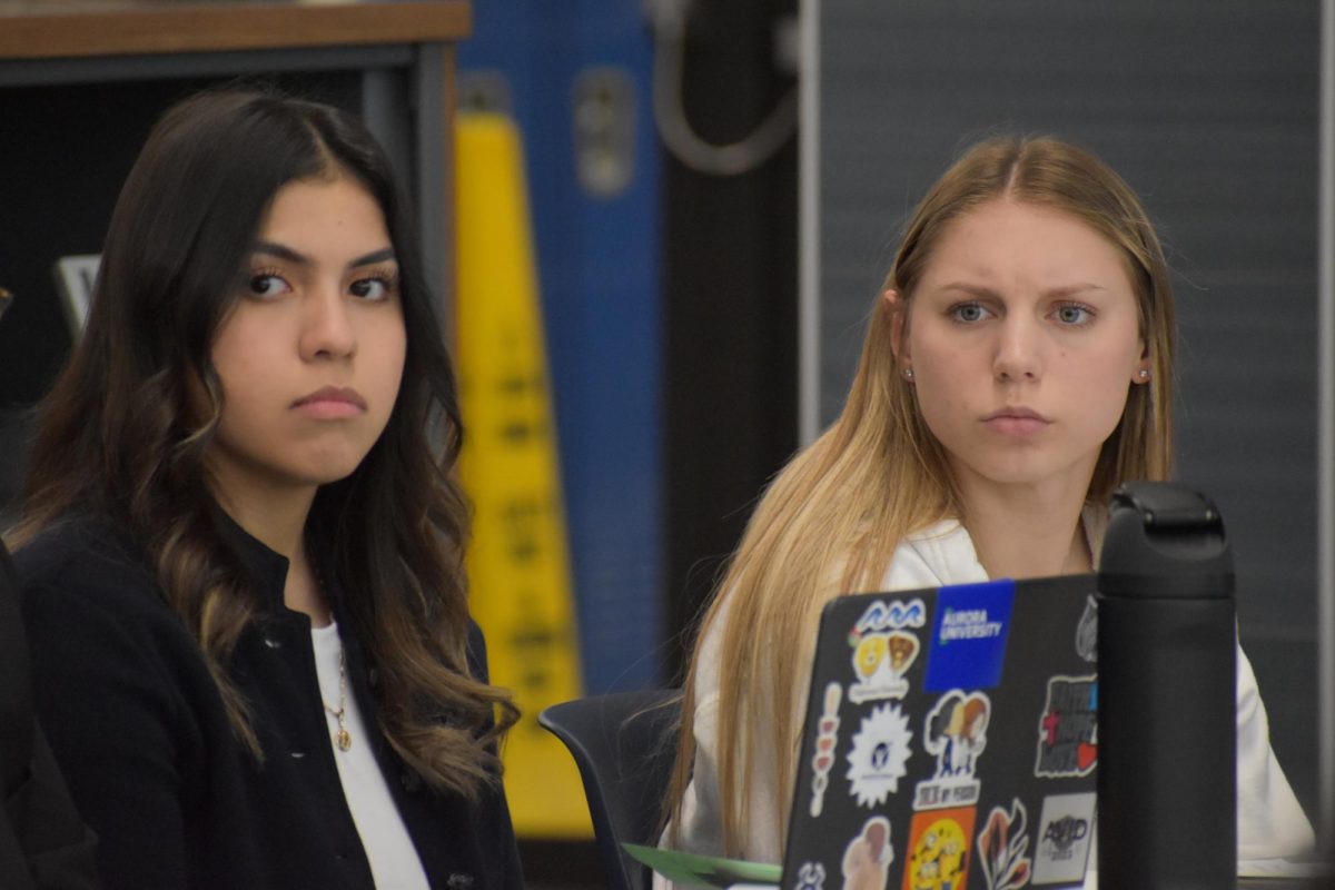 Evelyn Rubio and Kali Waller, both seniors, stare intently at the speaker in committee meetings on March 18th