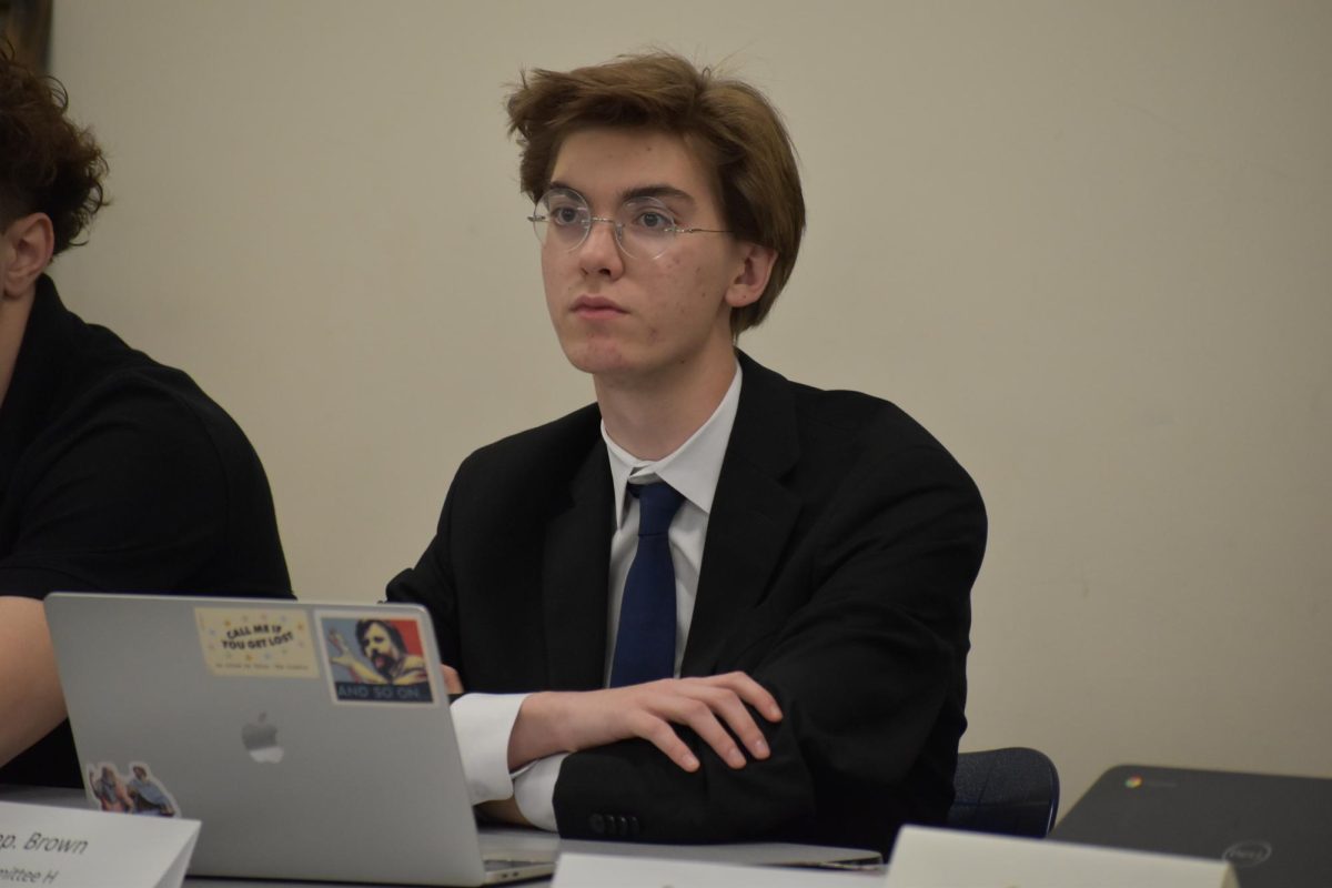 Democratic Majority Floor Leader Lucas Brown, a senior, listens intently to a presentation in his committee.