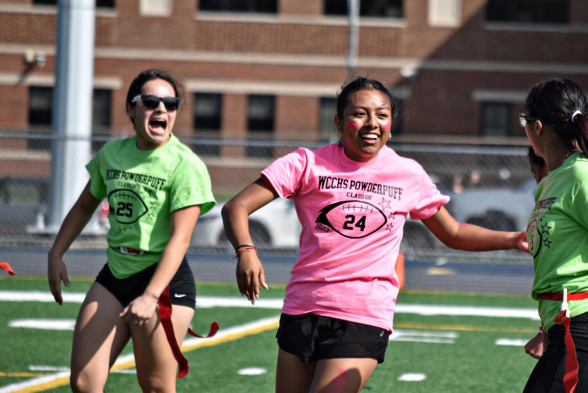 Senior+Judith+Benitez+rounds+the+corner+with+junior+Xamantha+Ramos+hot+on+her+heels+during+Sept.+29s+Powderpuff+game%2C+which+pitted+the+upperclassmen+against+each+other+in+a+flag+football+showdown.
