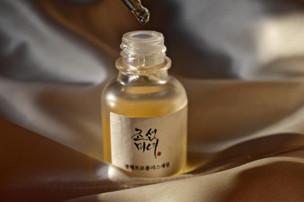 The glow serum is a golden color with a dewy, glossy consistency.