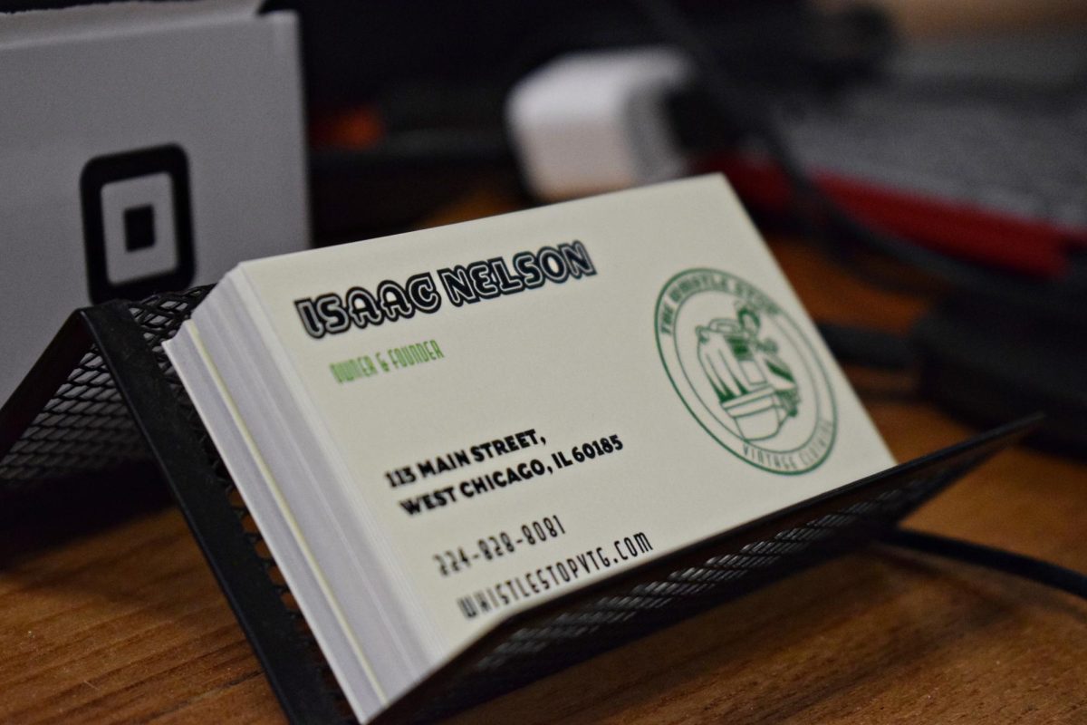 Business cards containing the stores information are situated for customers at the checkout desk.