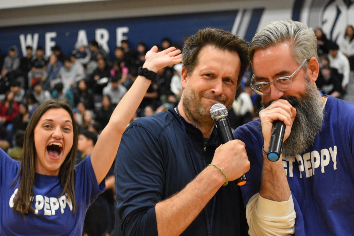 Profe Elizabeth Mastro photobombs Mitch McKenna and David Jennings as they work the mic during the games.