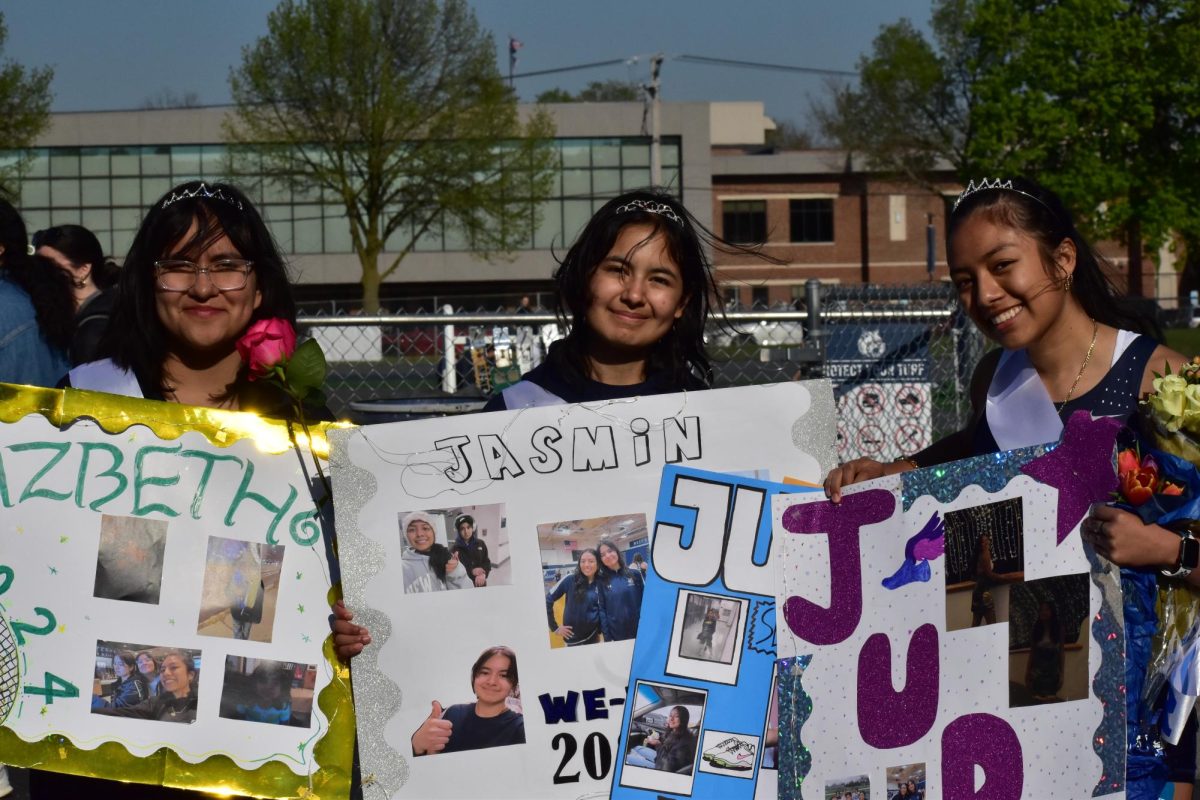 Seniors Lizbeth Camacho, Jasmin Leyva, and Judith Benitez pose for a picture together with their posters.