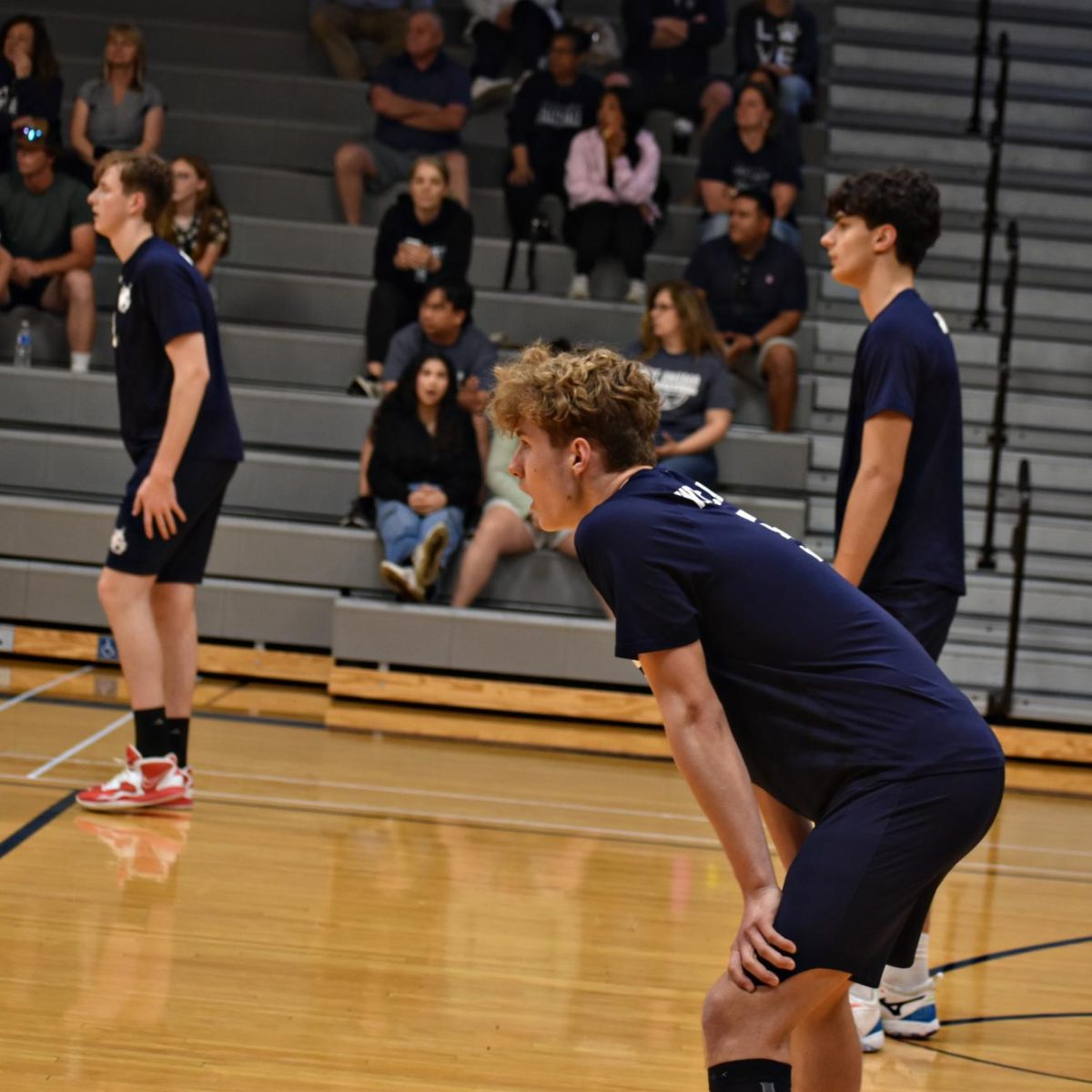 Junior Robert Witek anticipates the next serve during the final home game of the season.