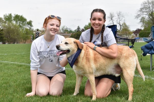 Sophia Newell and Emily Hanania posing with a handsome clean dog Atlas. 