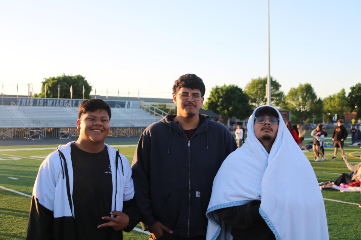 Seniors Issac, Eric and Ivan posing for a photo after playing some football.