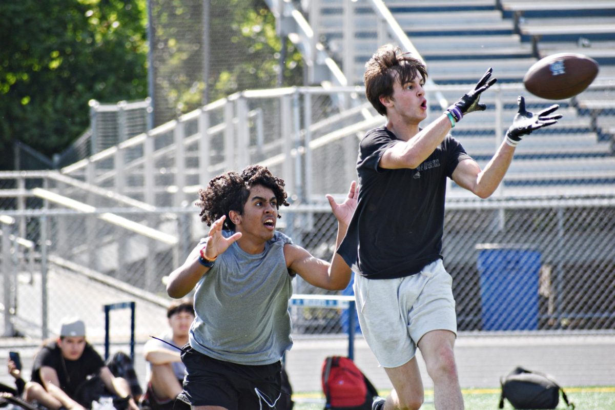 Senior Louis Zeitler intercepts a pass before junior Carter Naranjo can step in during offseason training in May 2024.