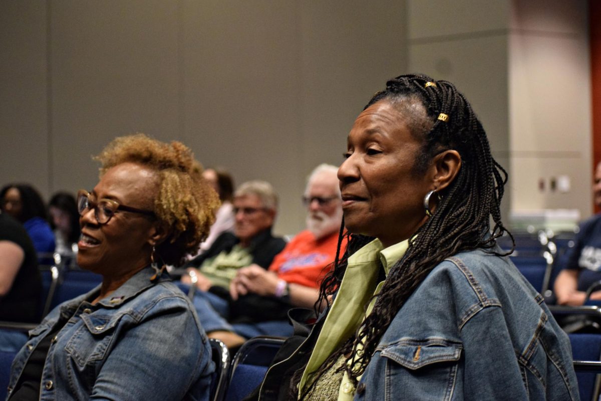 Caucus attendees listen as Judy Hunter presents her story on Aug. 20 at the Democratic National Convention.