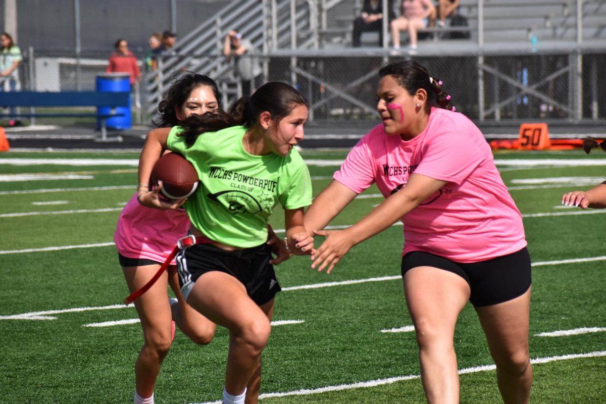 Then-junior Elina Velaso searches for an opening, while trying to keep her flag during last year's Powderpuff game.