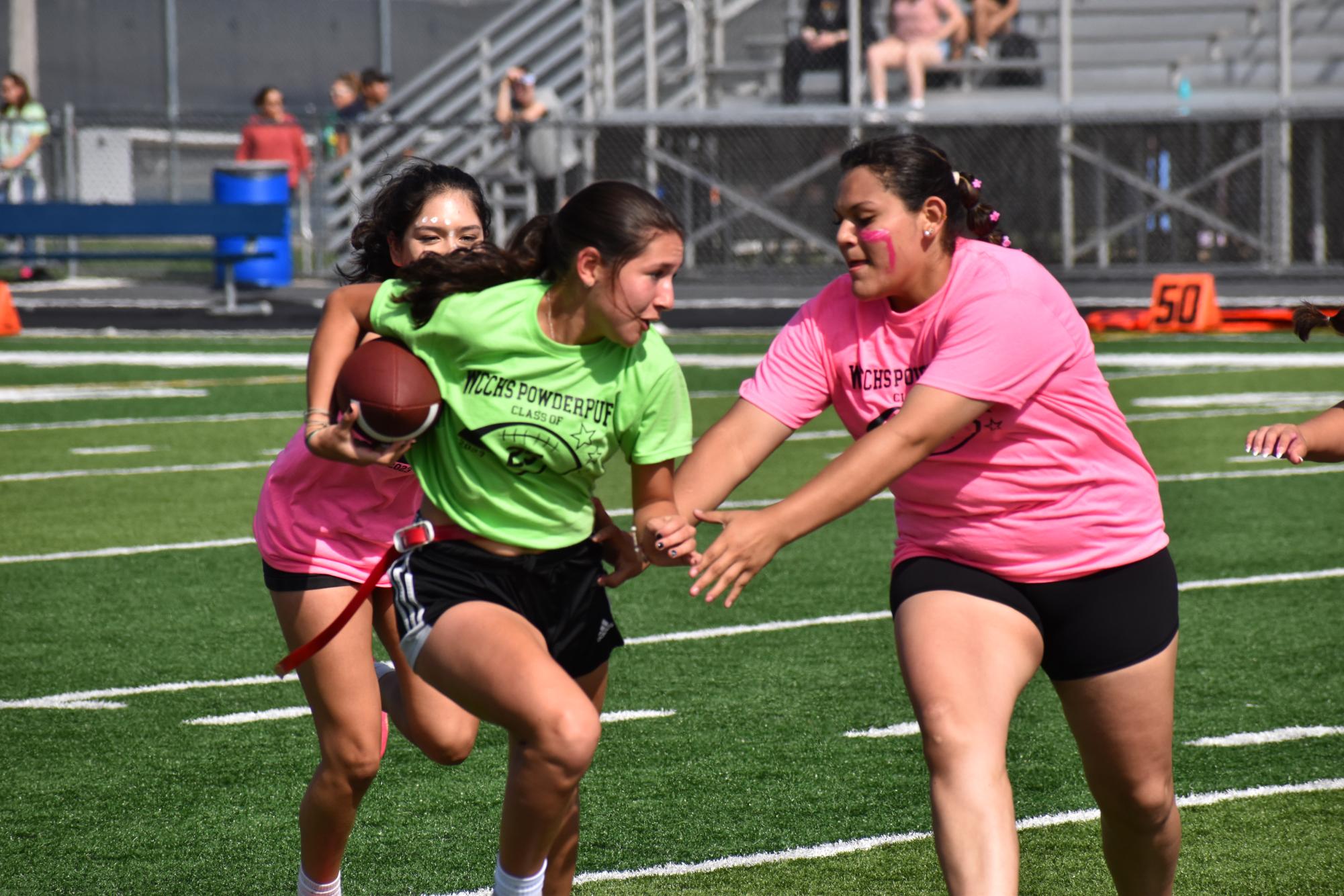 Then-junior Elina Velaso searches for an opening, while trying to keep her flag during last year's Powderpuff game.