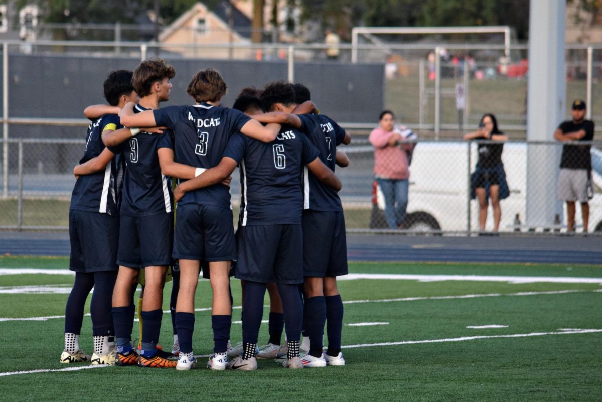 The boys' soccer team huddles before kicking off during their Sept. 12 game against Lyons Tonwship. 