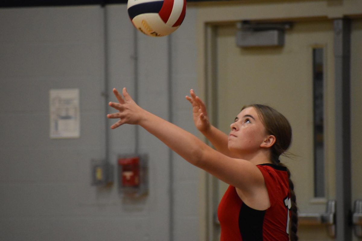 Benjamin eighth grader Ally Voight focuses as she serves the ball.