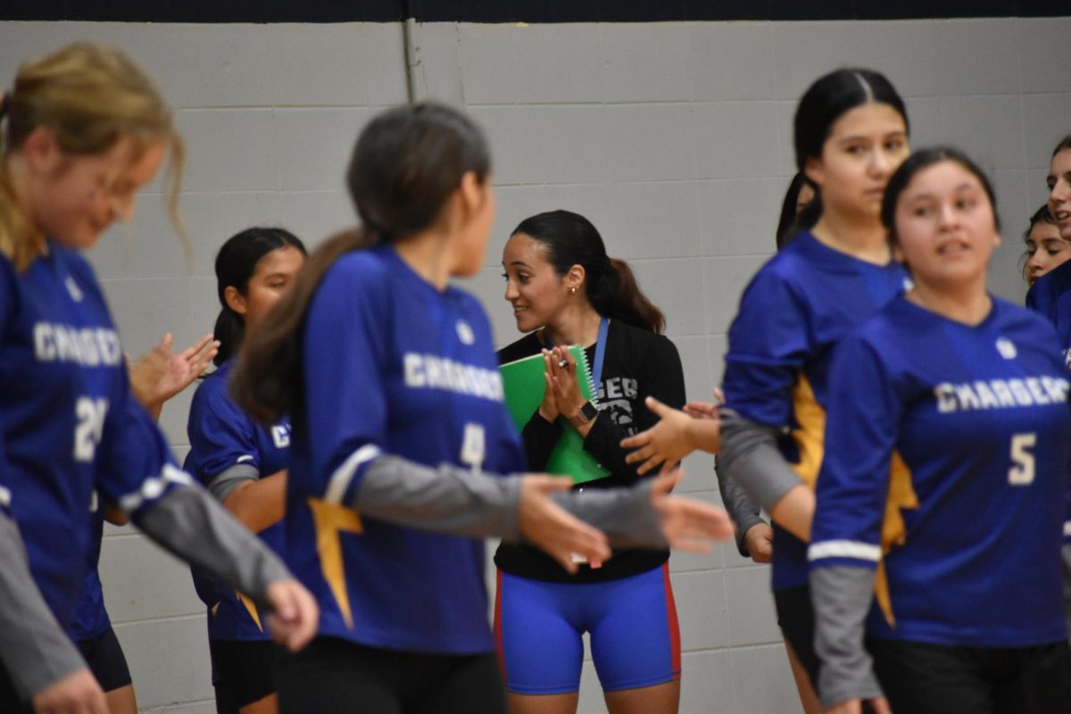 Coaches pull aside players to discuss strategies. 