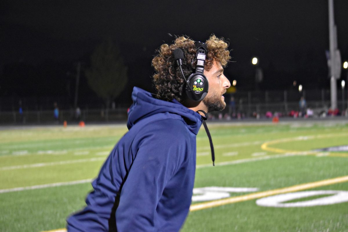 Coach Malko Odishoo yells out encouragement from the sideline during the Sept. 27 game against South Elgin.