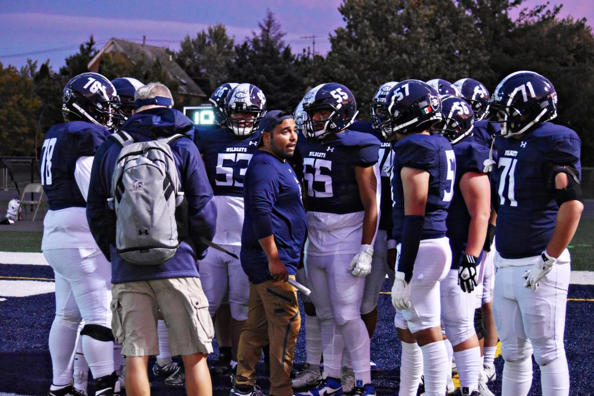 Players prep for the game against South Elgin with input from the coaches.