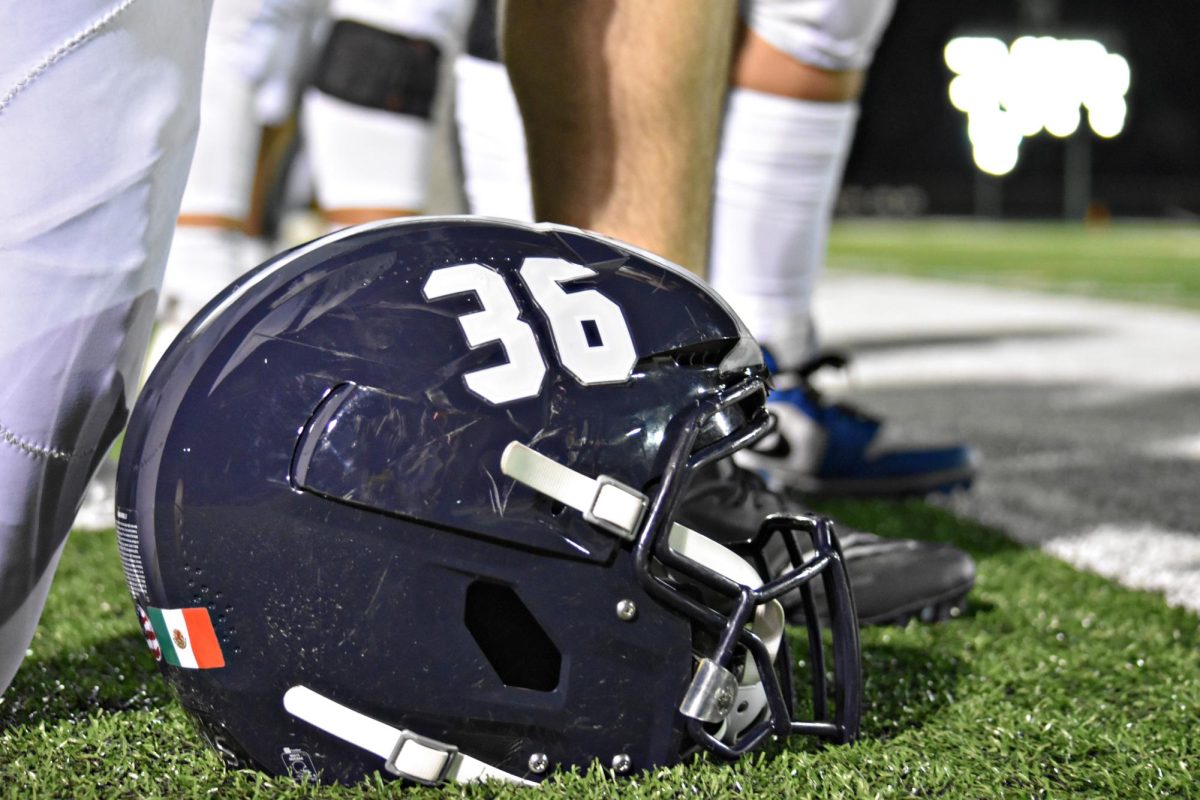 Jayden Rosario’s helmet rests on the field, a symbol of the hard-fought battle between the Wildcats and South Elgin.