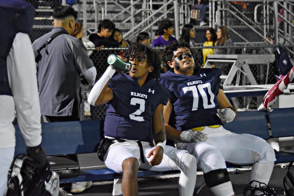 Juniors Carter Naranjo and Ean Arizmendi hydrate between plays.