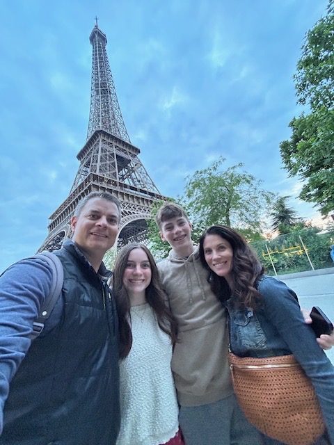 Laurie Van Gorp takes a selfie in front of the Eiffel Tower, a site she has visited many times. (Photo courtesy of Laurie Van Gorp)