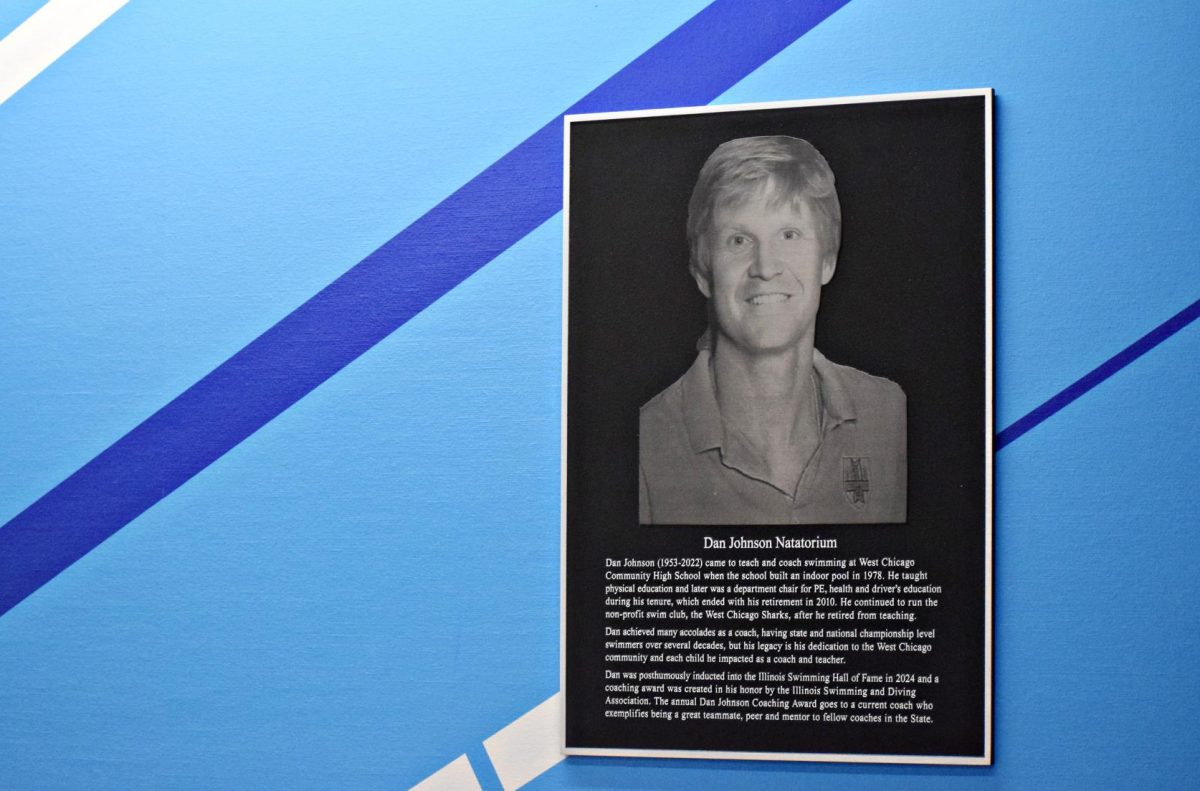 A plaque sits outside the Dan Johnson Natatorium and explains his impact on the program, and the wider world of swimming.