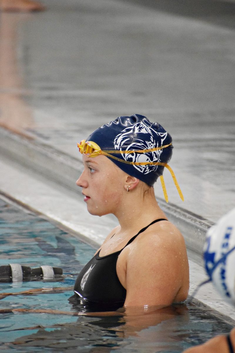 Sophomore Emery Larson, who walked away from the meet with two medals, takes a moment during warmups to take in the scene at the Dan Johnson Natatorium.