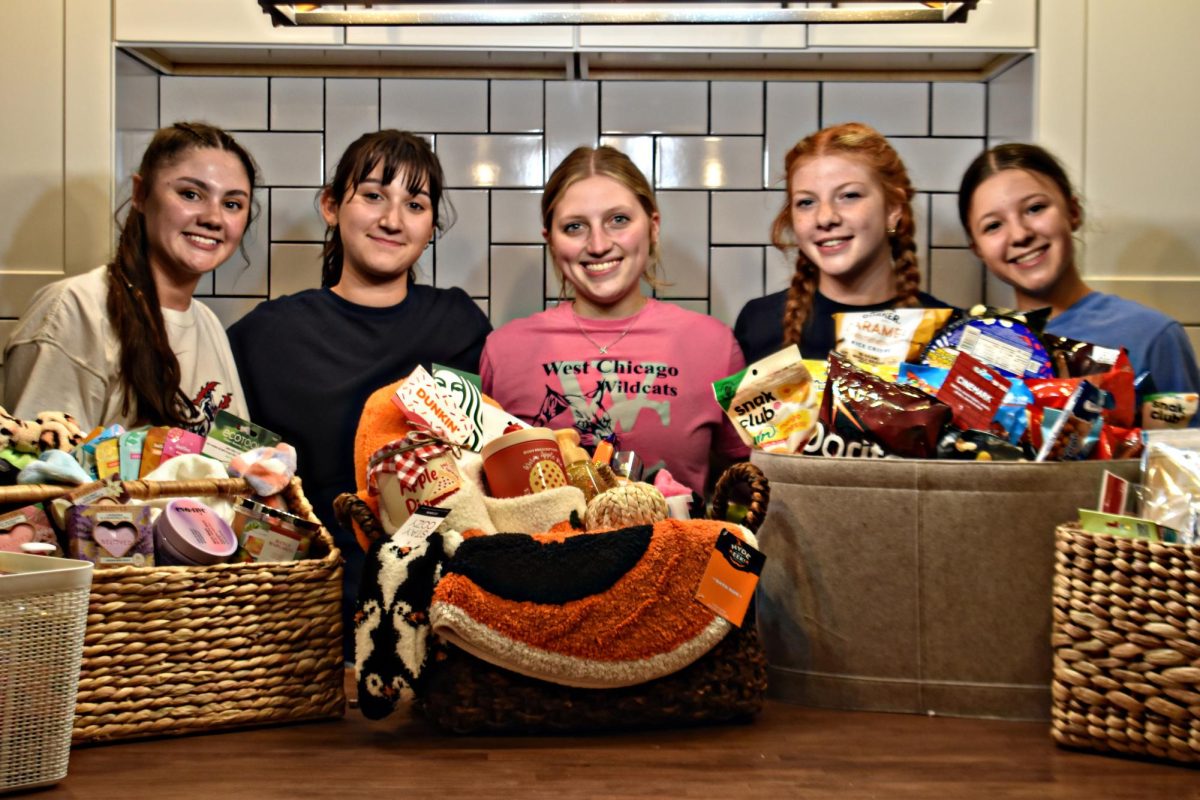 Seniors Jasmyn Trigueros, Faith Hernandez, Lauren Dusing, Emily Hanania, and Mia Zapata gear up for Dig Pink by preparing raffle baskets. 