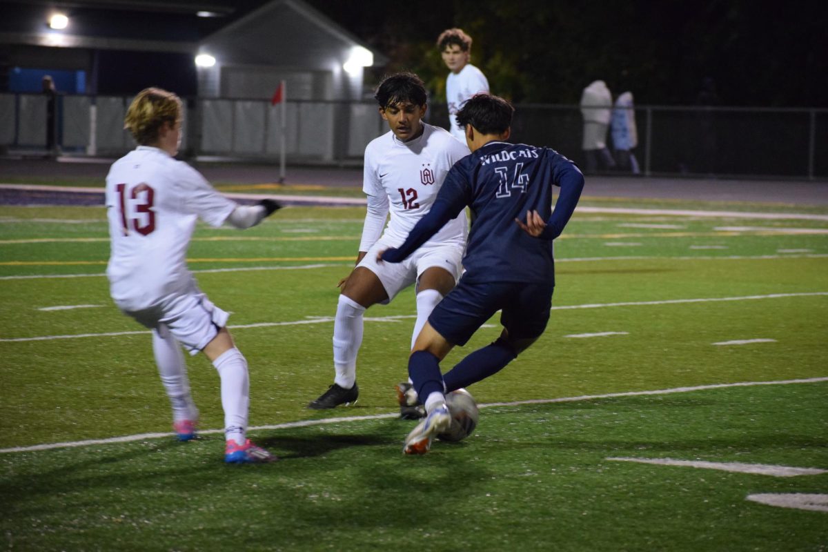 Junior Aidan Durbin faces off against the Wheaton Academy players during the Oct. 14 game. 