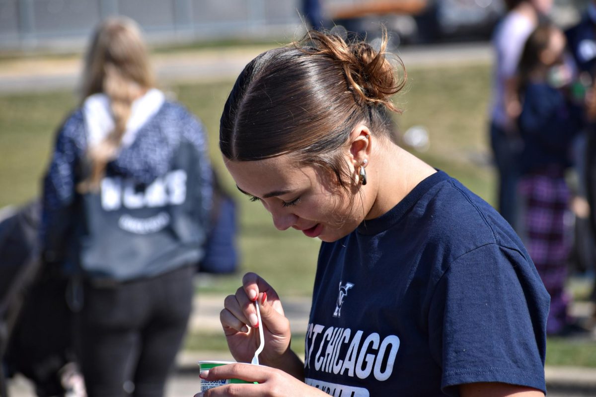 Junior Taylor Frake enjoys Kona Ice before she hops onto the volleyball team's Homecoming float.