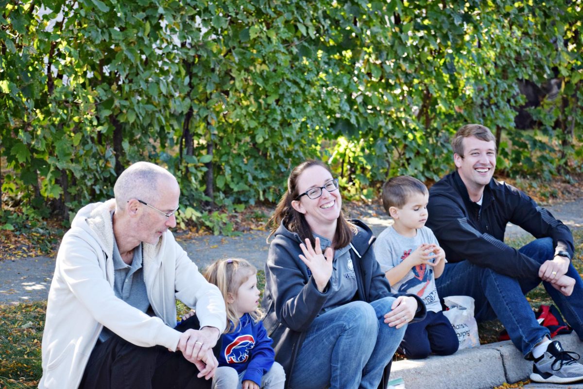 English teacher Lauren Stewart waves to parade-goers as she takes in the sights with her children.