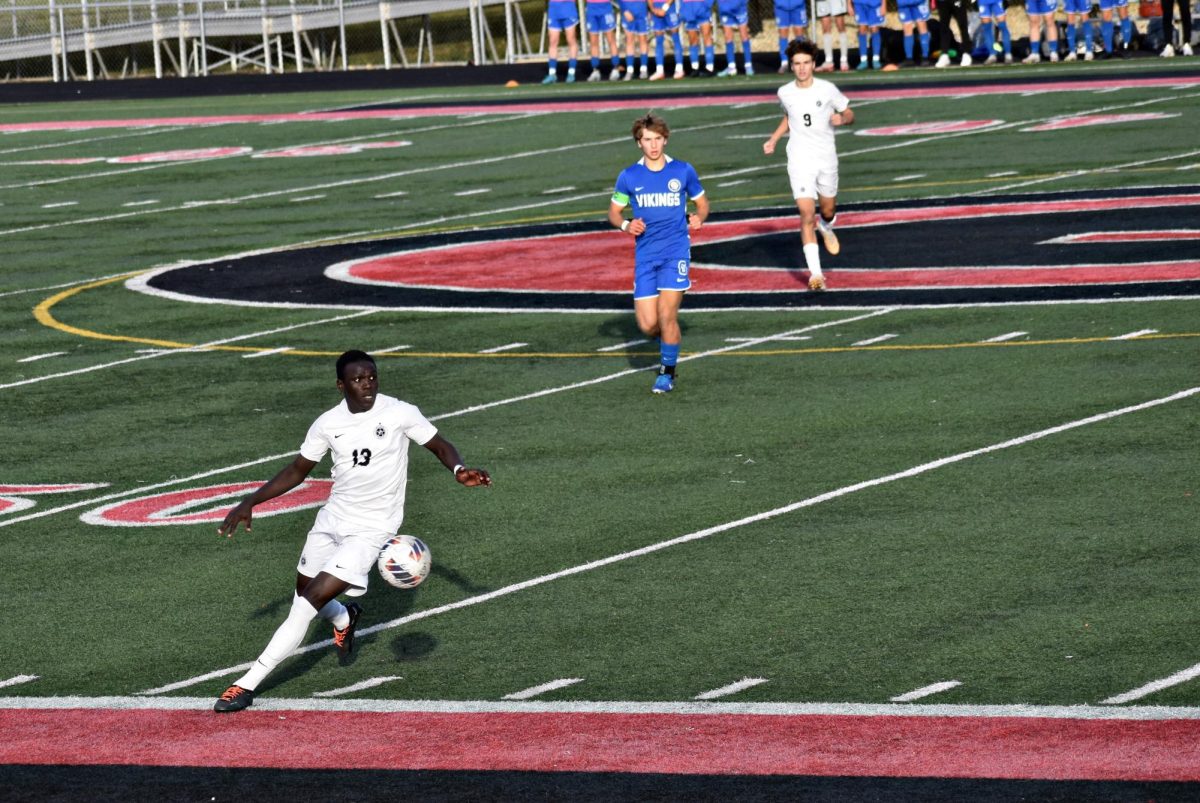 Forward Gafoa Kuku drives the ball down the field in the hopes of gaining ground - and points - over Geneva. 