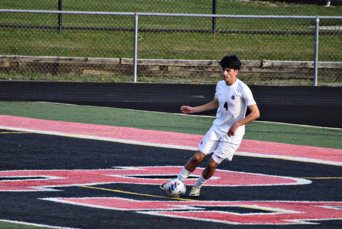 Pedro (Rocky) Nicoski-Rios, a senior and defender, works to kick the ball into safer territory.