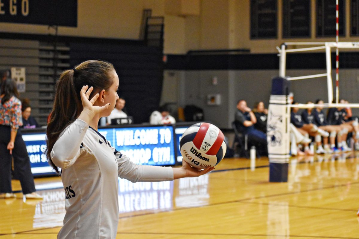 Senior Sophia Newell prepares to serve the ball in the Oct. 23 match-up against Addison Trail.