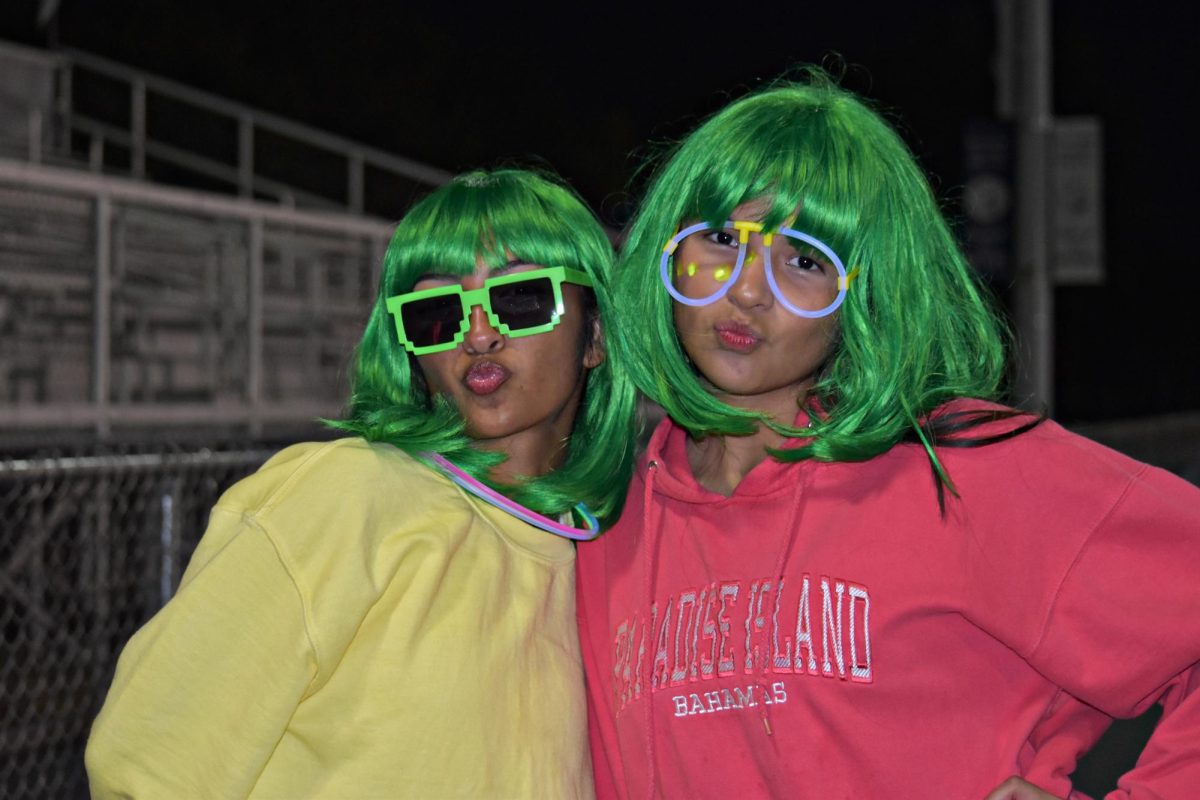 Even reporters get into the spirit sometimes: junior Gabriella Castro dones a wig and glow glasses on Neon Night.