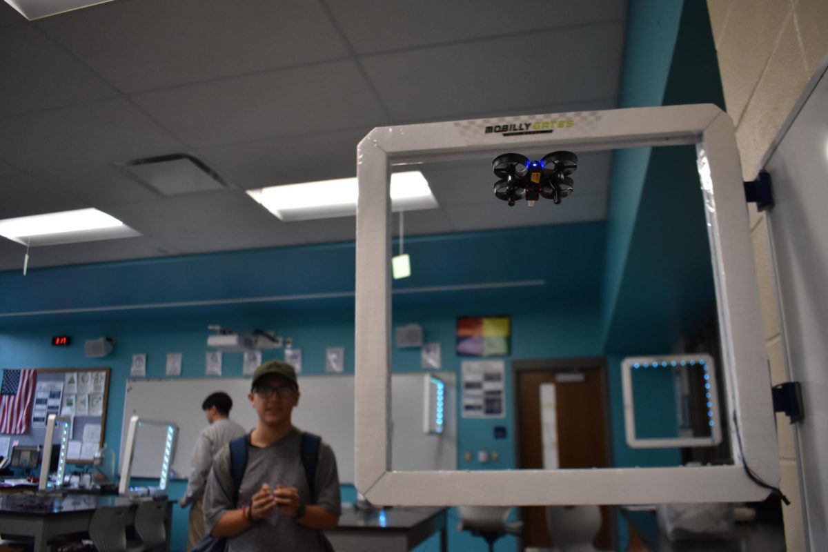 A member of the Drone Club from last year practicing their skills by flying drones through an obstacle course they designed.