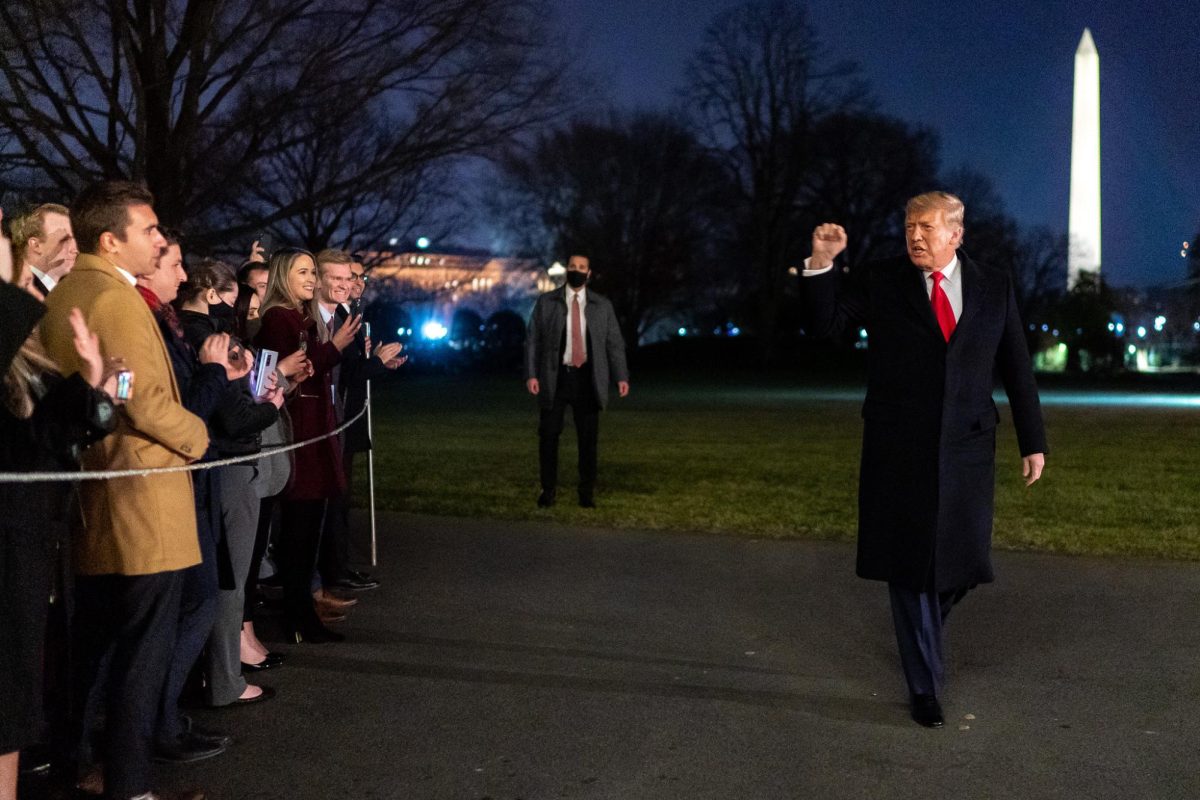 President Donald J. Trump gestures to White House staff with a fist pump after disembarking Marine One on the South Lawn of the White House Tuesday, Jan. 12, 2021, following his trip to Texas. (Official White House Photo by Tia Dufour)