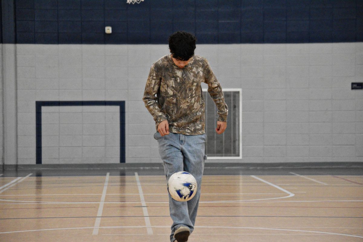 The player completes the full rotation, positioning their foot to regain control and continue juggling without letting the ball drop.