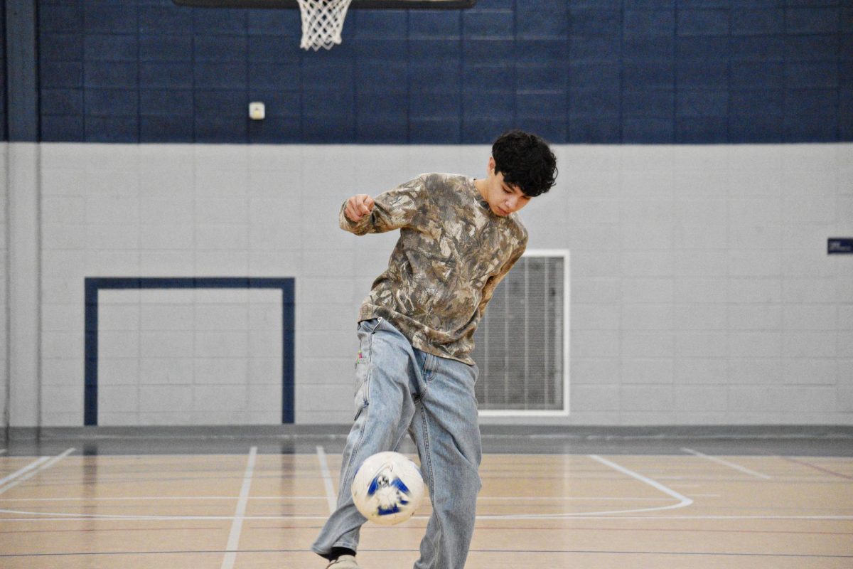 The ball is flicked slightly upward as the player prepares to initiate the circular motion.