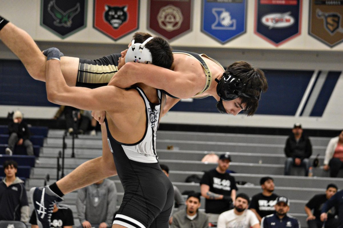 Senior Ryan Alvarado lifts his Sabres opponent off the mat in a dominant display of strength during West Chicago’s Senior Night.