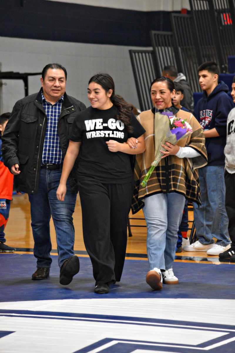 Senior Dayana Mata walks the mat with her family, celebrating her contributions to the West Chicago wrestling program.