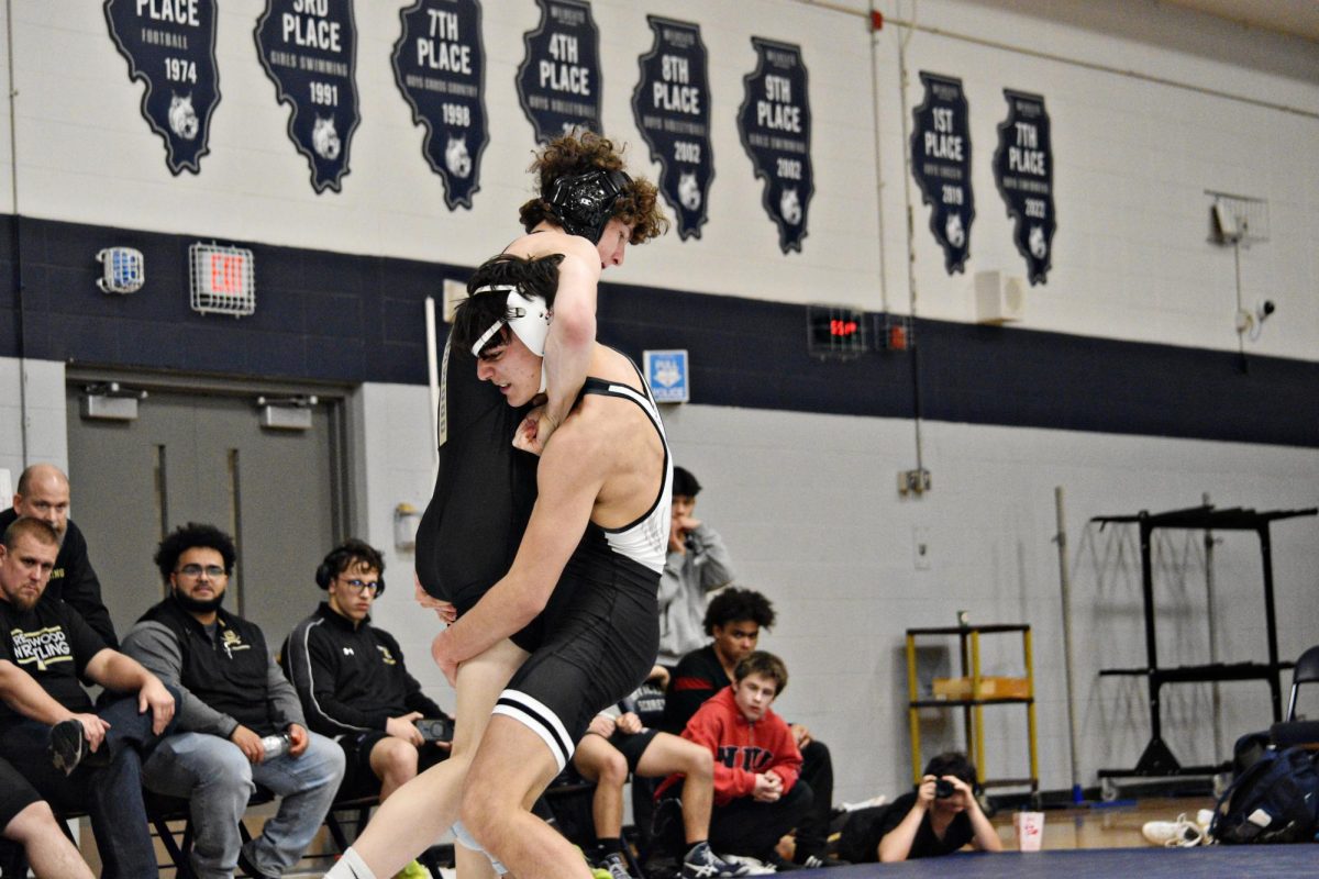 Senior Donovan Avila, wrestling in the 132-pound weight class, executes a decisive takedown against his Sabres opponent during West Chicago's Senior Night on Jan. 29 in Bishop Gym.