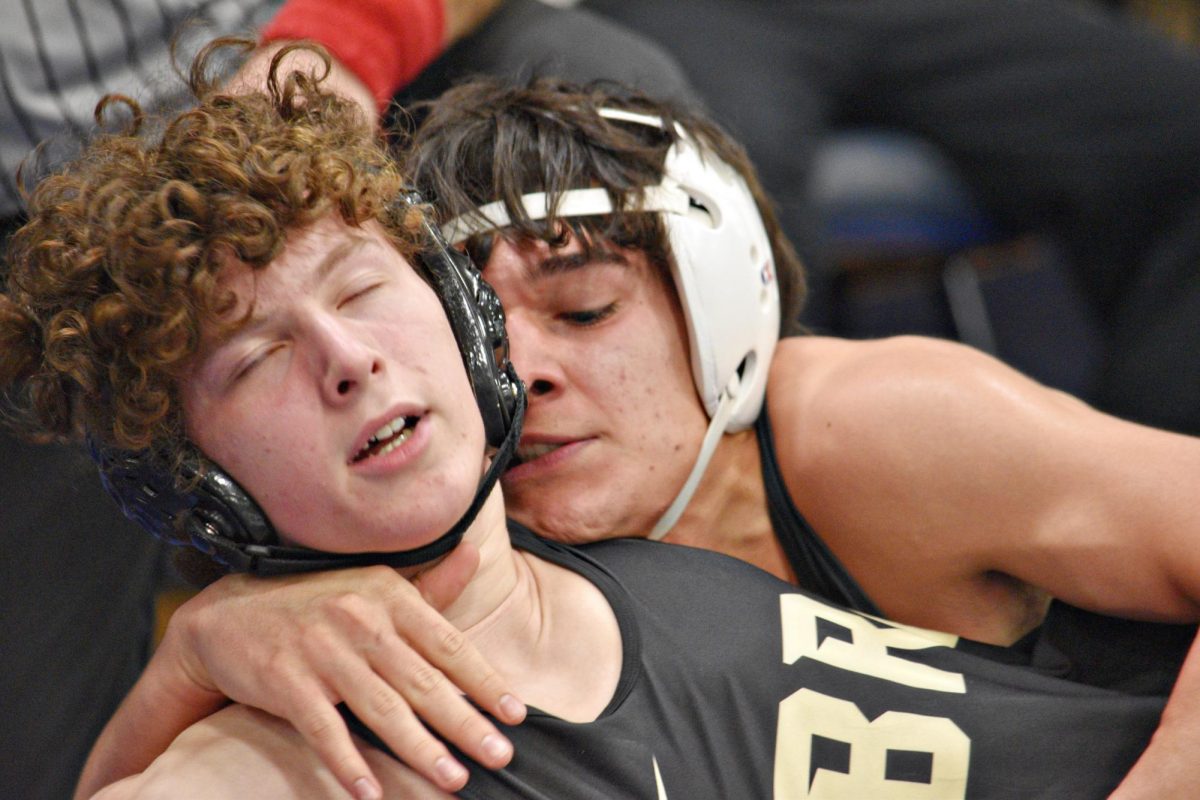 Senior Donovan Avila dominates his Sabres opponent, securing control on the mat during West Chicago’s Senior Night on Jan. 29 in Bishop Gym.