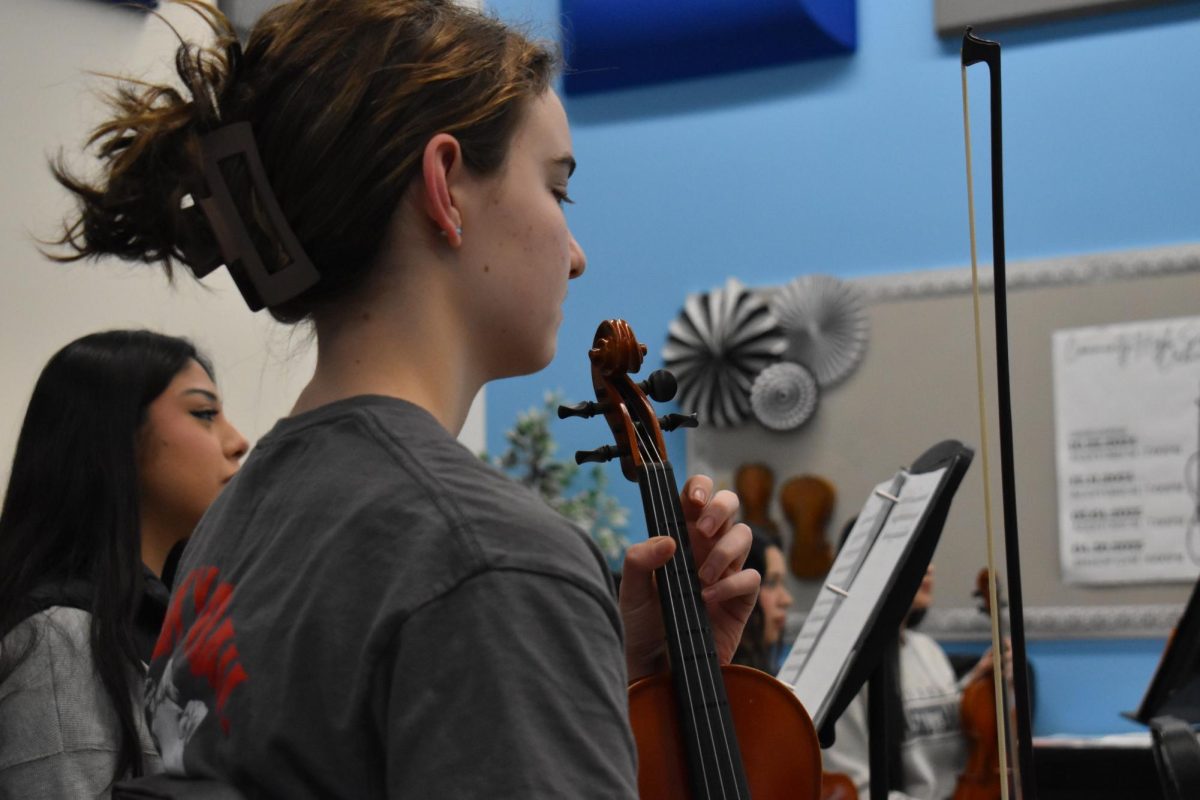 Sophomore Elisa O'Brien practices violin for the up coming concert at West Chicago Community High School in Feb. 2025.