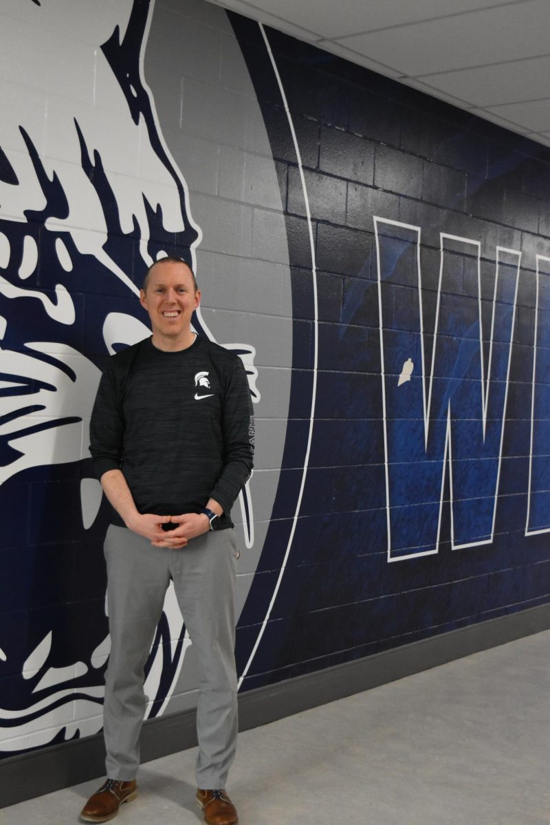 Principal Will Dwyer in front of the Wildcat mural at entrance B- near his office. 