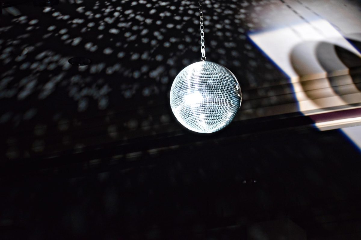 A disco ball provides additional atmosphere during the band concert on March 5 in the auditorium.