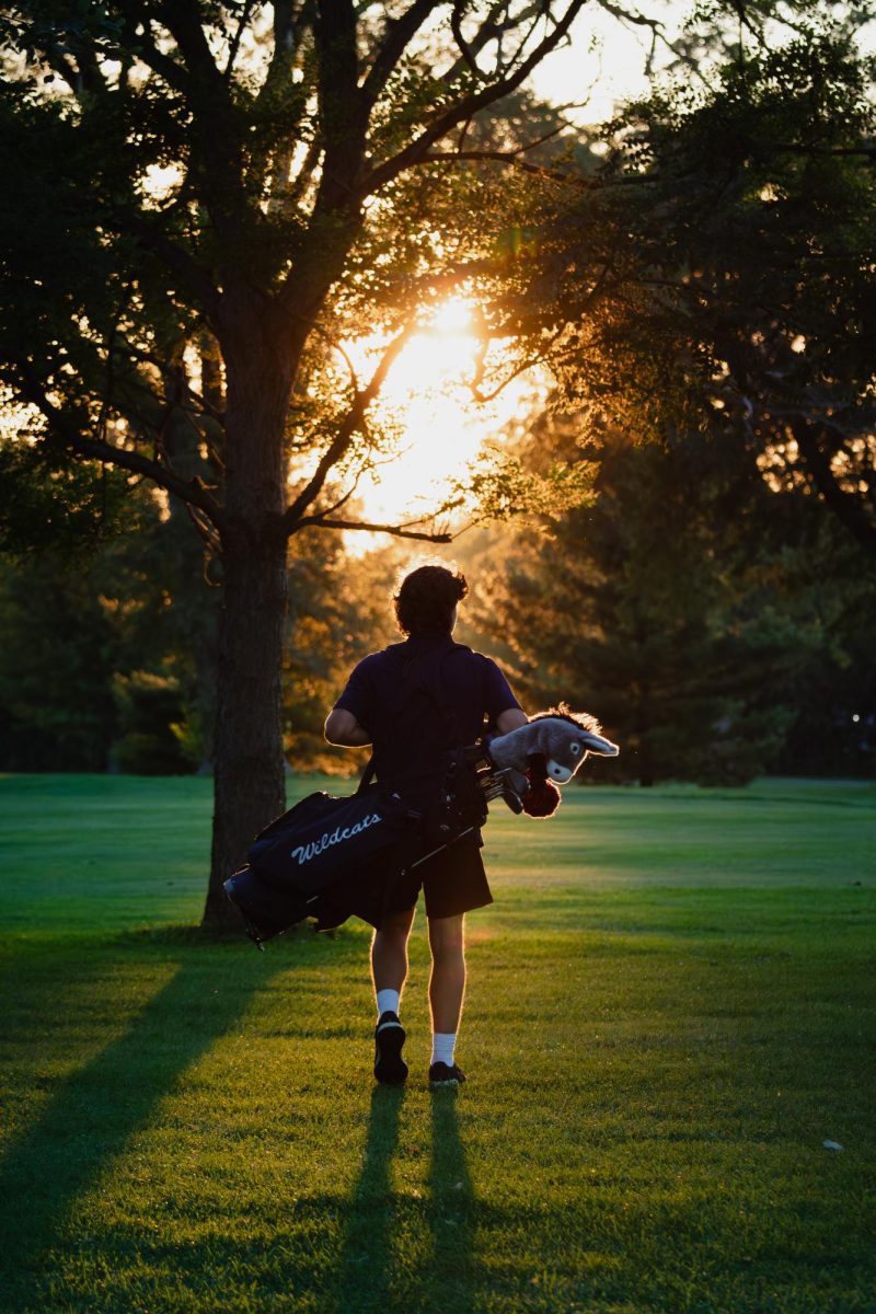 Senior Sam Zalak crosses the fairway to reach the next hole on the 16th of Sep.