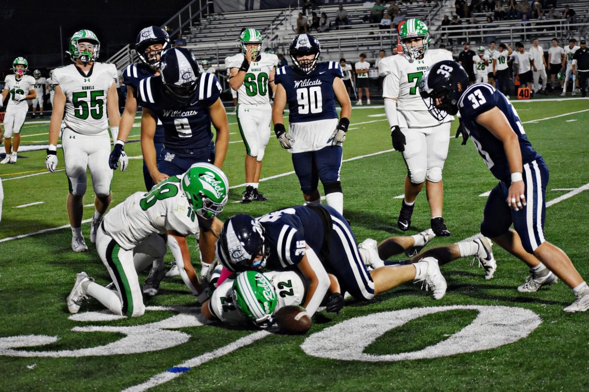  Senior Jayden Rosario makes  a tackle on Ridgewood’s No. 22, senior Nicco Camillo, as the Wildcats secured against the Rebels at Memorial Field on Sept. 19. Rosario forced an incomplete pass during the second quarter. 