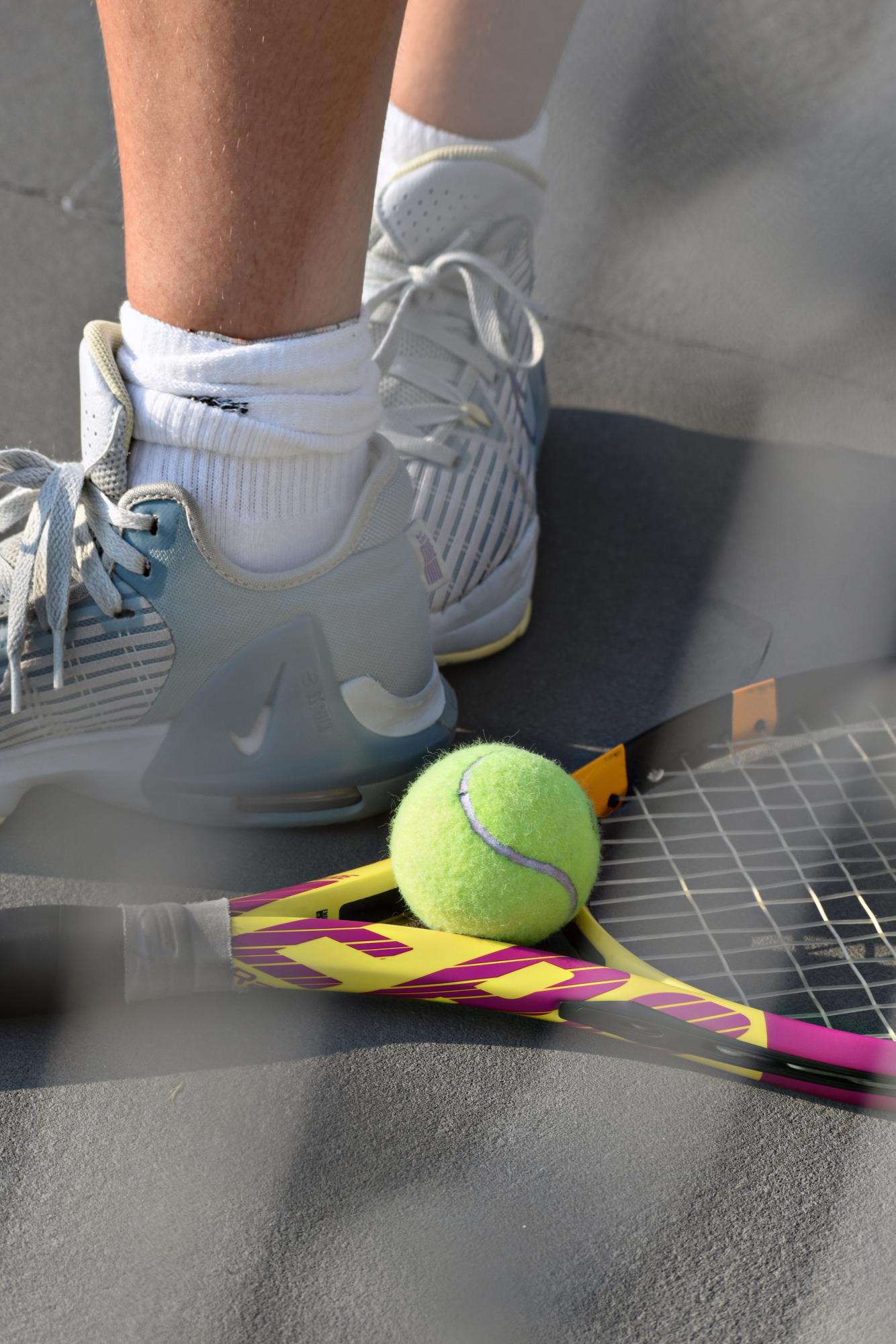 A tennis ball rests on the racket as a player gets ready to serve during WEGO’s home match against Ridgewood on Sept. 11.