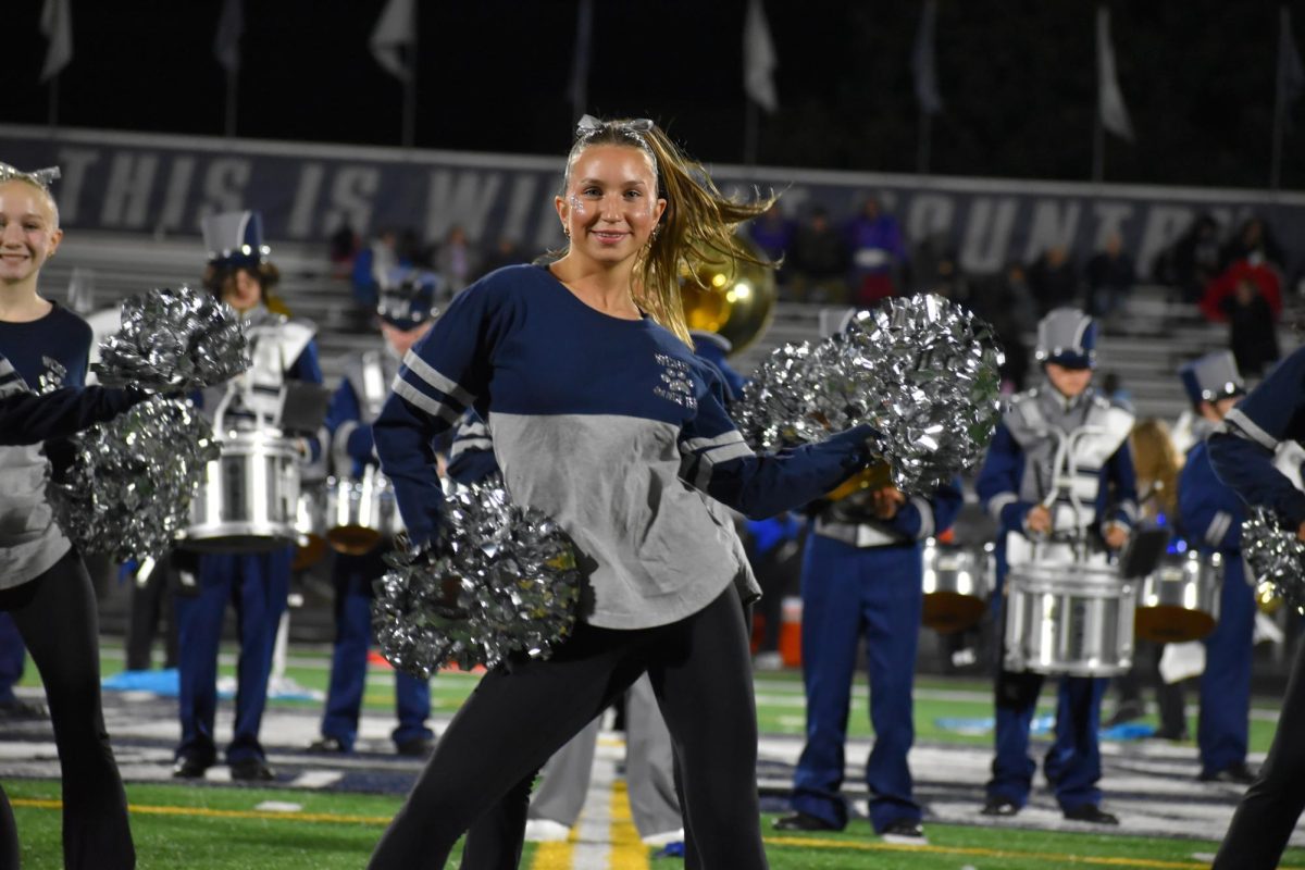Dance team member and senior Lia Mazurski performs in her last first halftime show of her high school career.